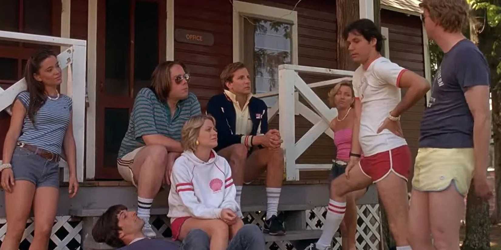 A group of people gathered on a cabin porch in Wet Hot American Summer