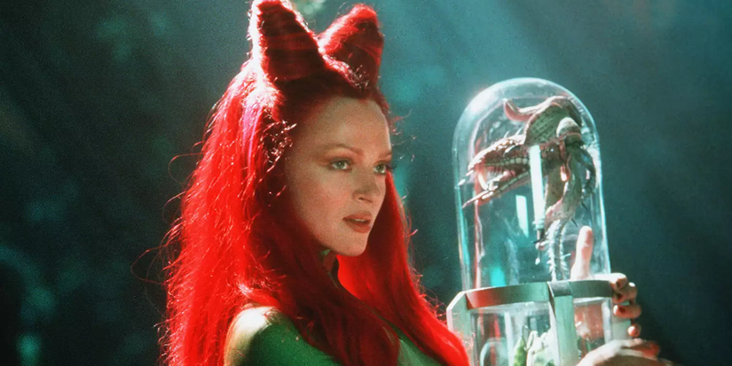 Poison Ivy holding a glass case with a carnivorous plant in Batman & Robin