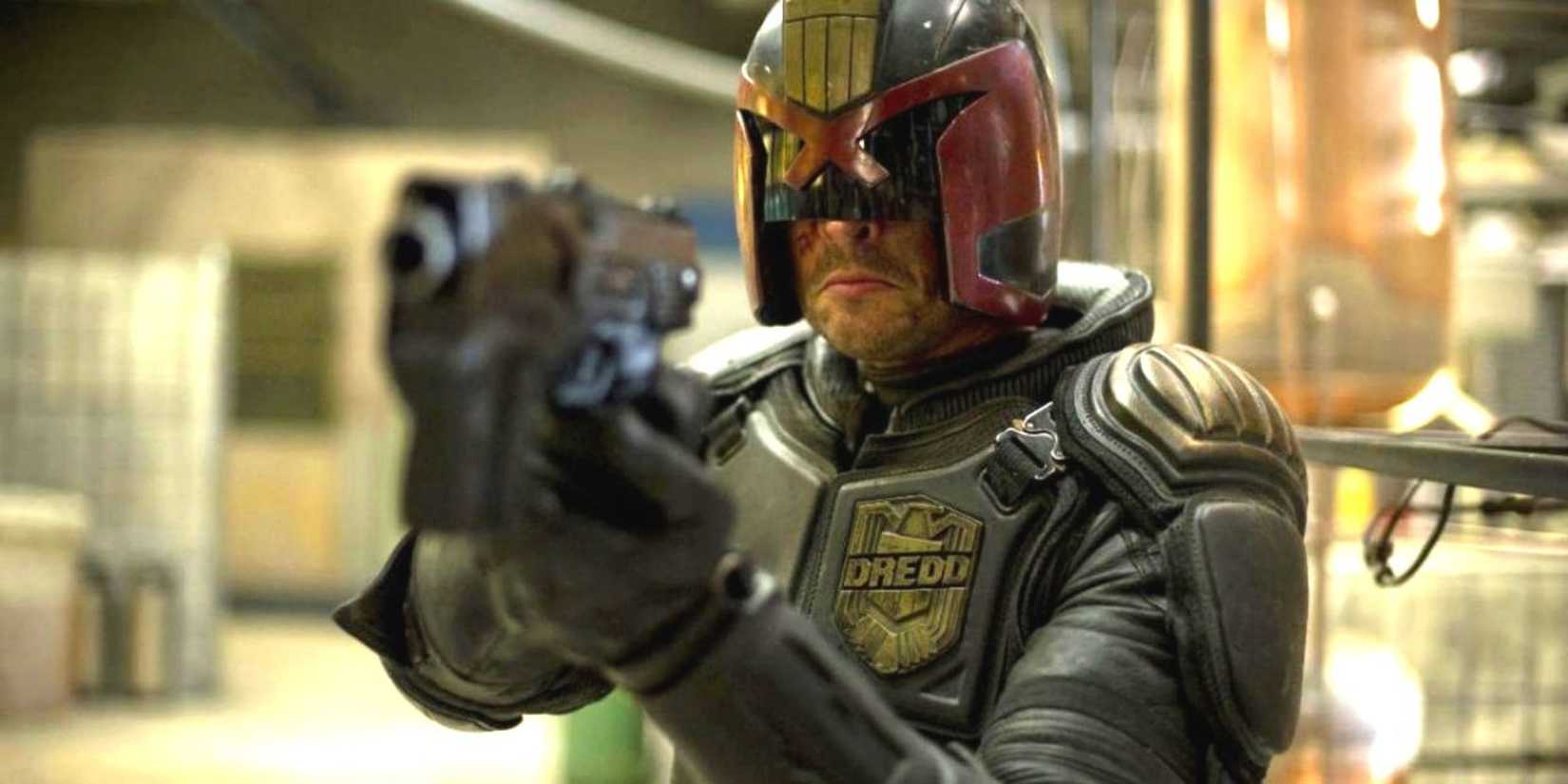 Judge Dredd point a gun in Dredd.