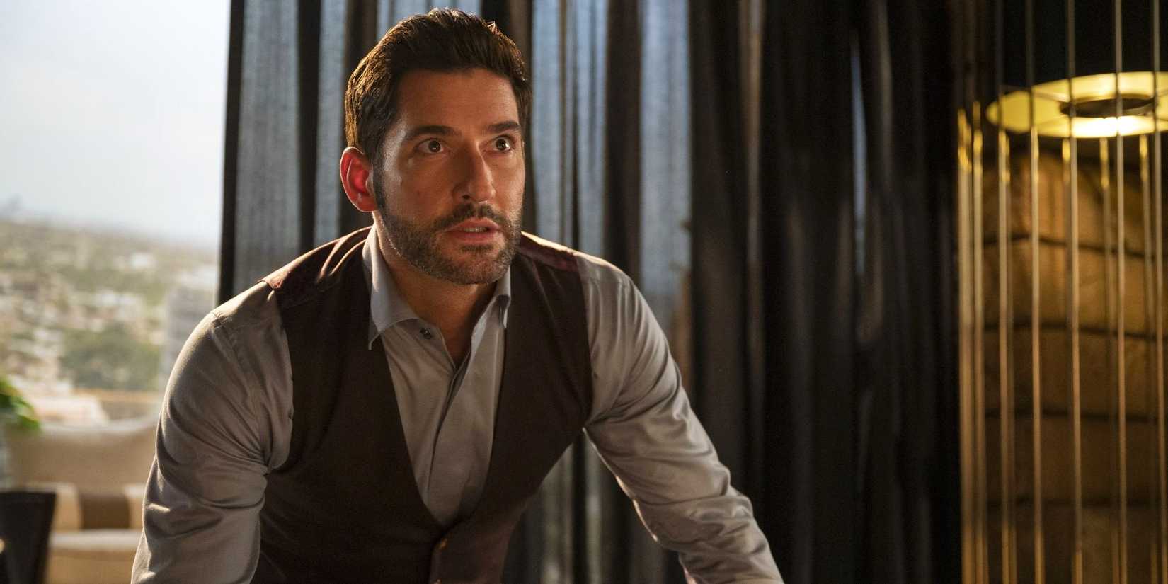 Tom Ellis as Lucifer Morningstar in a button-down shirt and vest in Lucifer