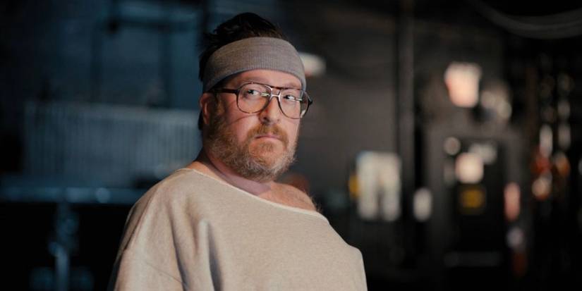 Michael Cyrul Creighton as Howard Morris looking at the camera in Only Murders in the Building.