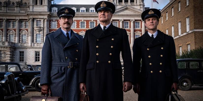 Charles Cholmondeley, Ewen Montagu, and Ian Fleming standing on a street looking ahead in Operation Mincemeat