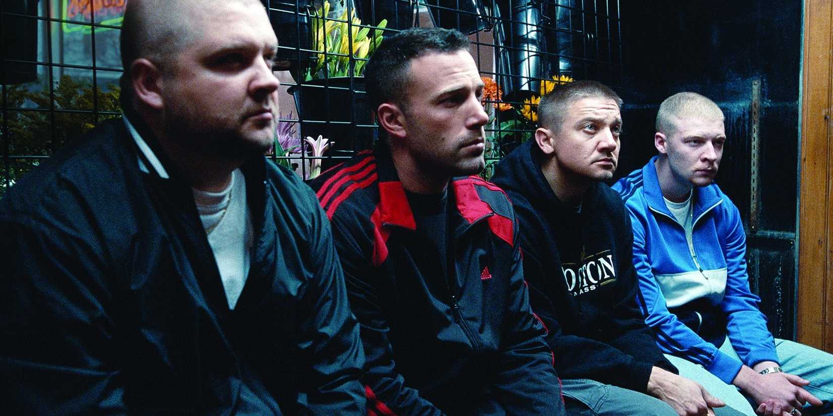 Ben Affleck and Jeremy Renner sit with two others all looking ahead in the Town.