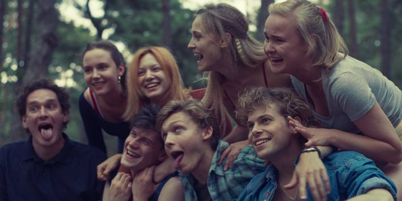Young cast of Netflix's 'The Woods' smiling and goofing around.