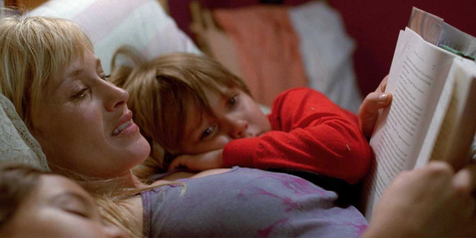 Patricia Arquette cuddles with two children and reads them a story at bedtime in Boyhood.