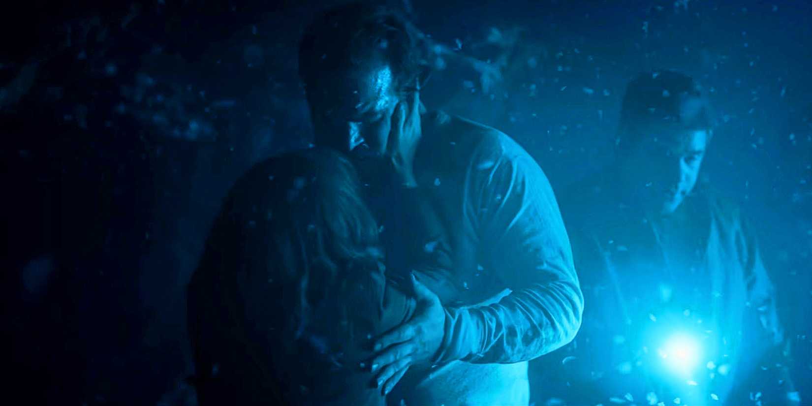 David Harbour and Winona Ryder as Joyce and Hopper embrace in The Dig Dug in Stranger Things.