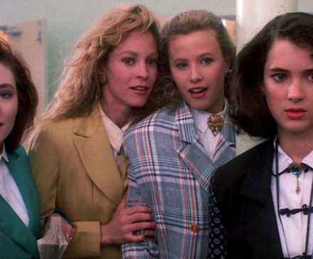 Winona Ryder as Veronica and Shannon Doherty, Lisanne Falk, and Kim Walker as three Heathers standing together in Heathers