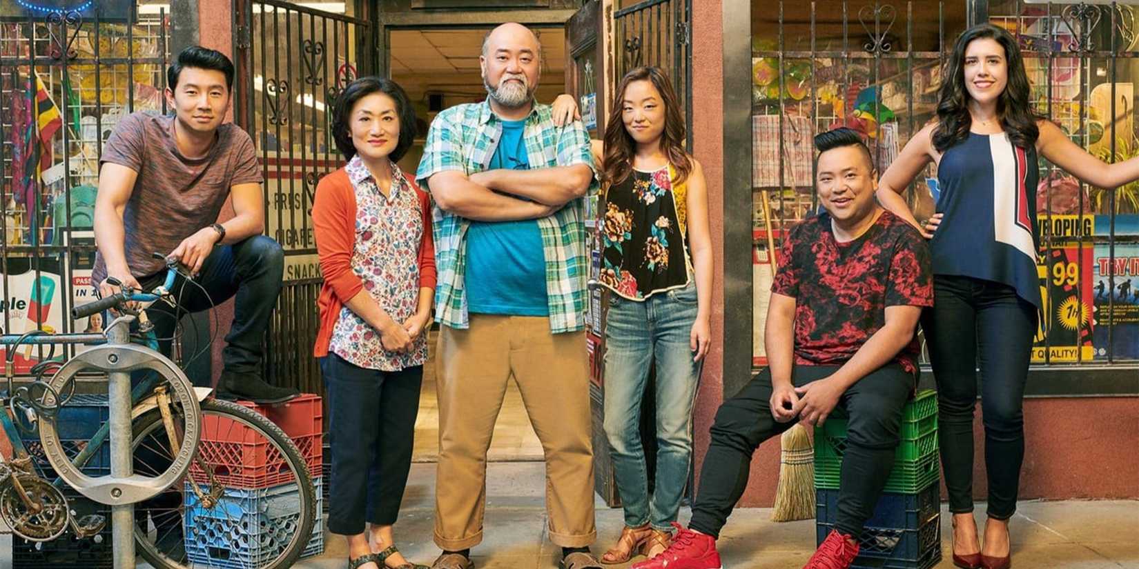 The cast of Kim's Convenience standing together and facing the camera, smiling.