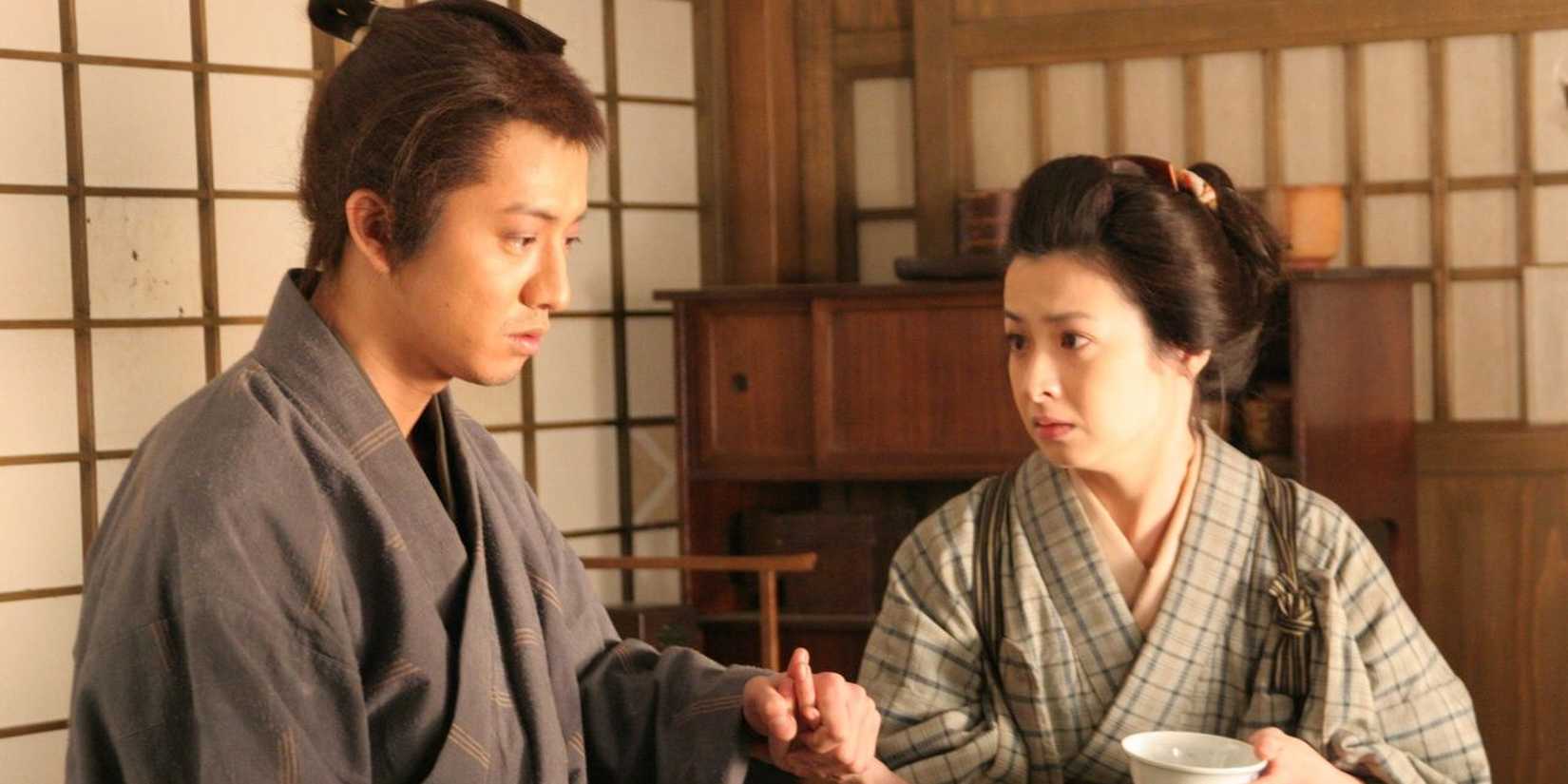 A husband and wife sit together in Love and Honor