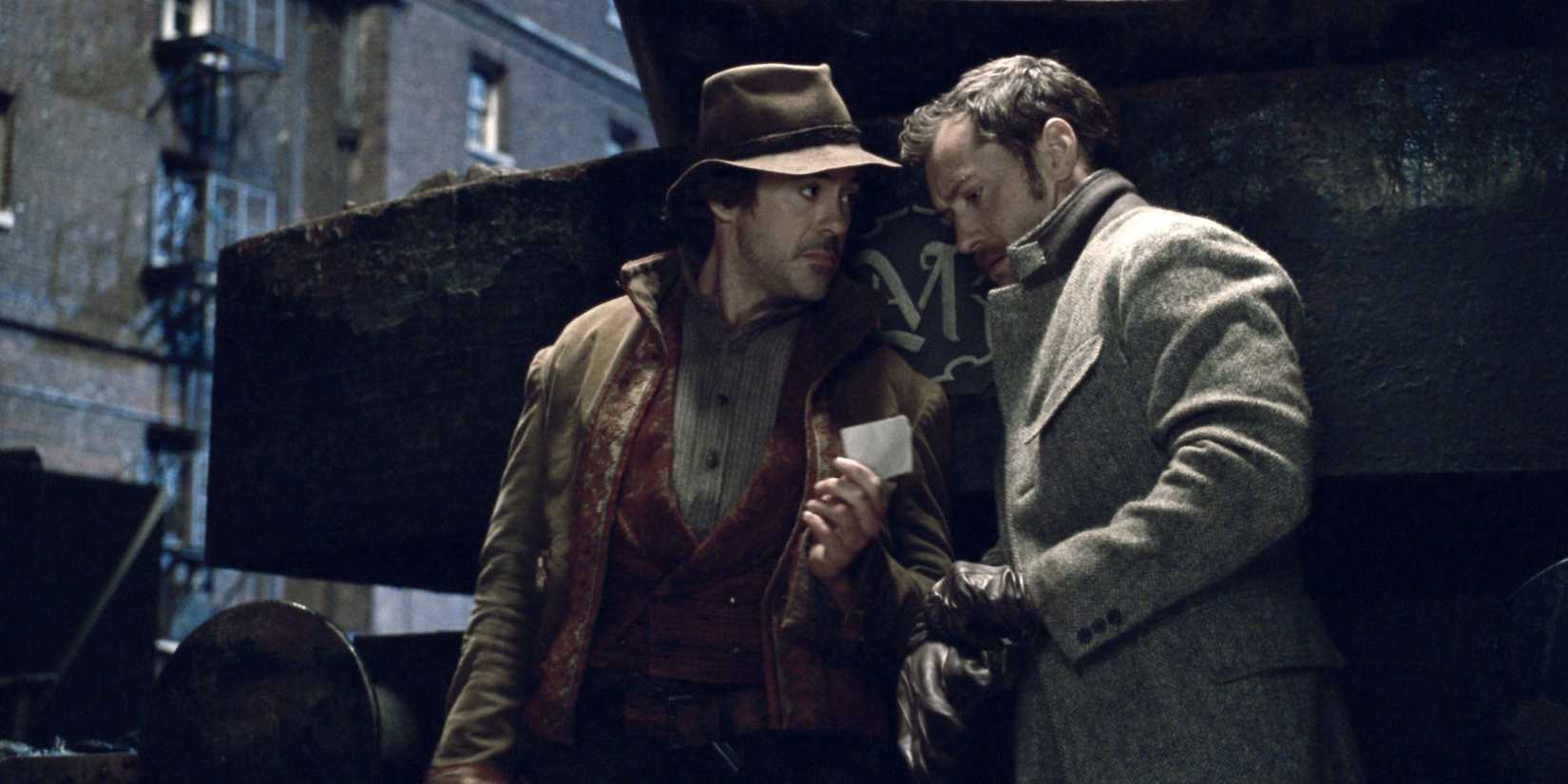 Two men are talking in the dark