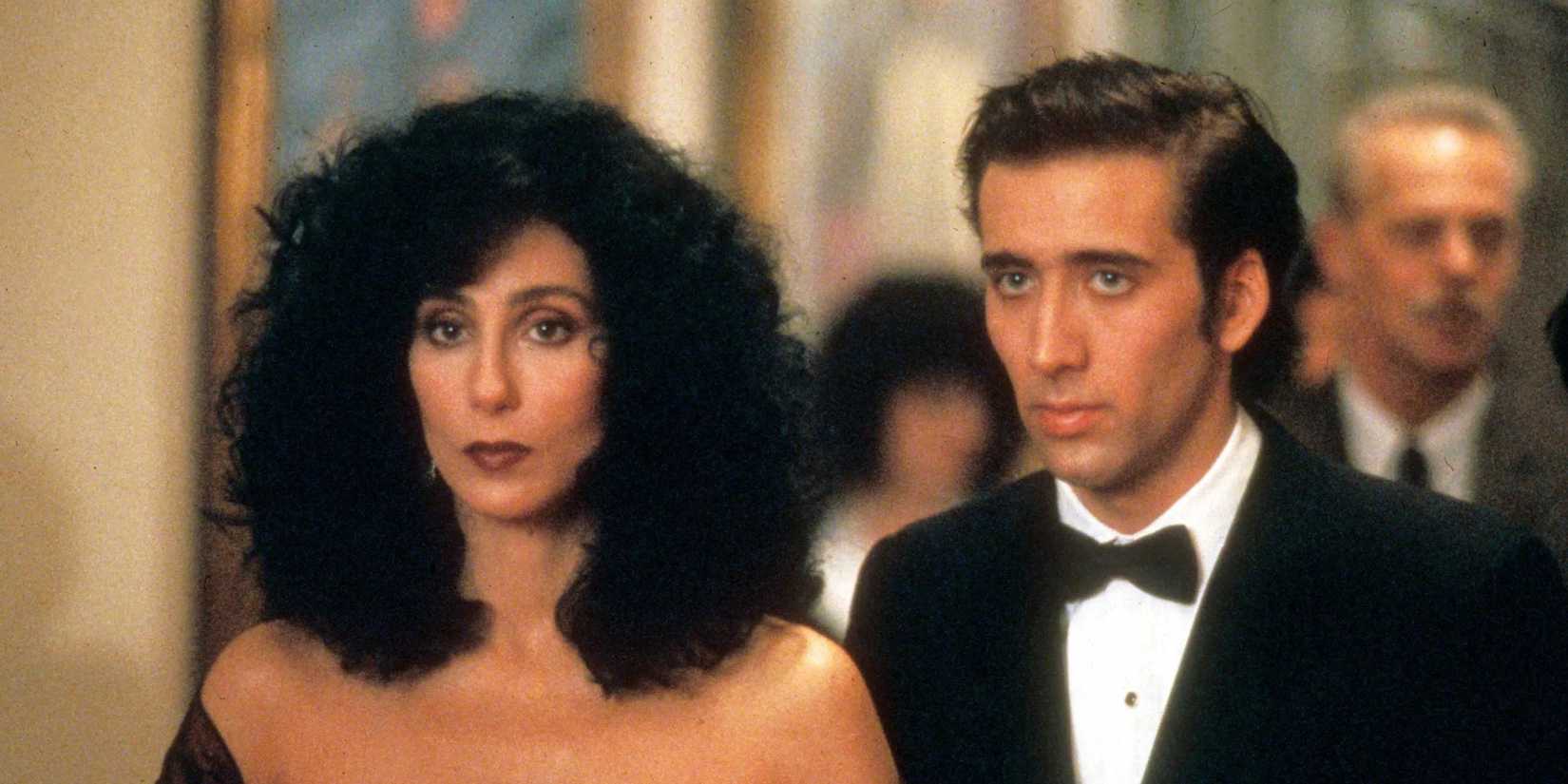 Cher and Nicolas Cage attend a party dressed in a tuxedo and a fine dress. 