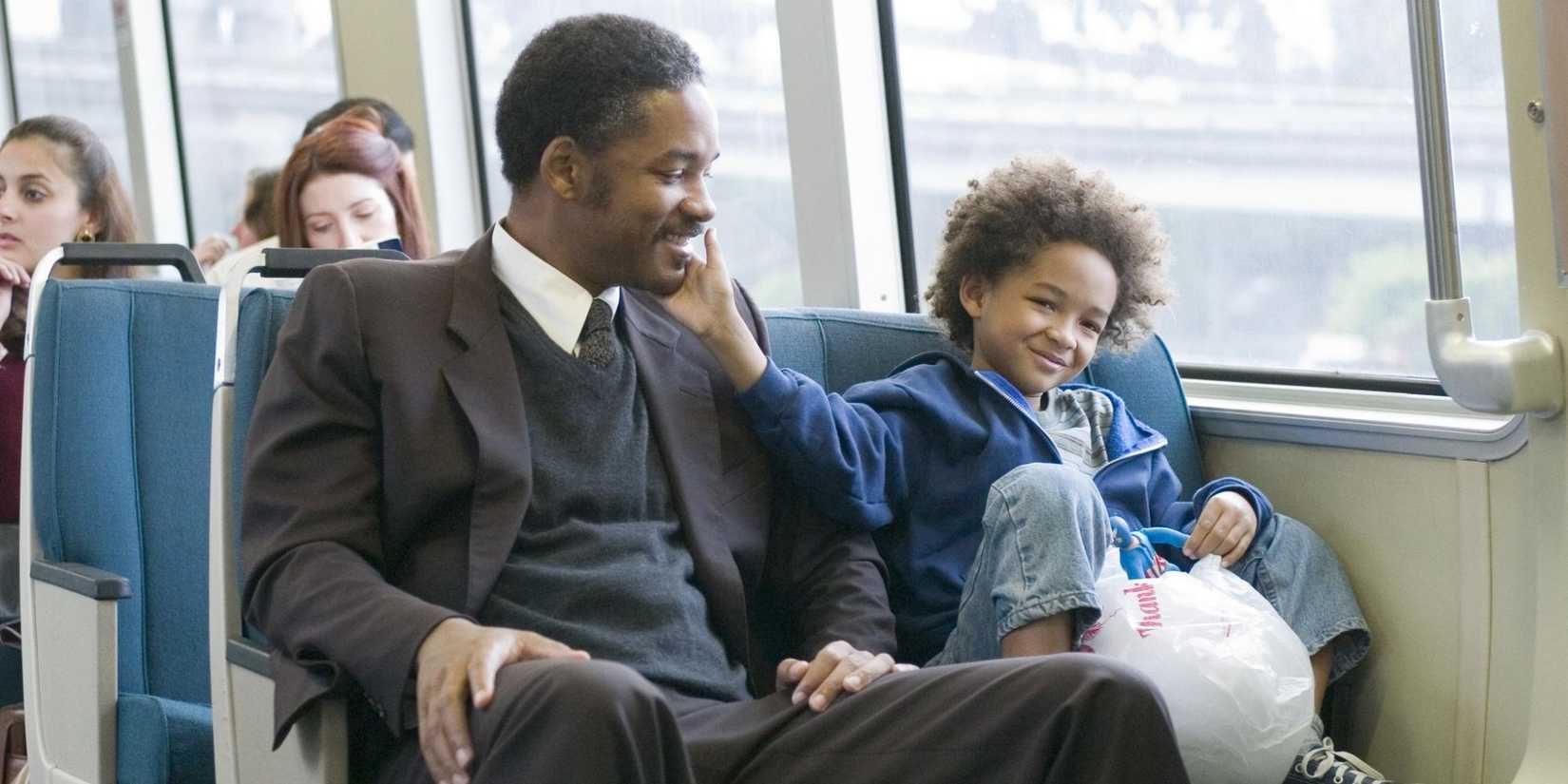 Will and Jaden Smith riding the bus and smiling in The Pursuit of Happyness.