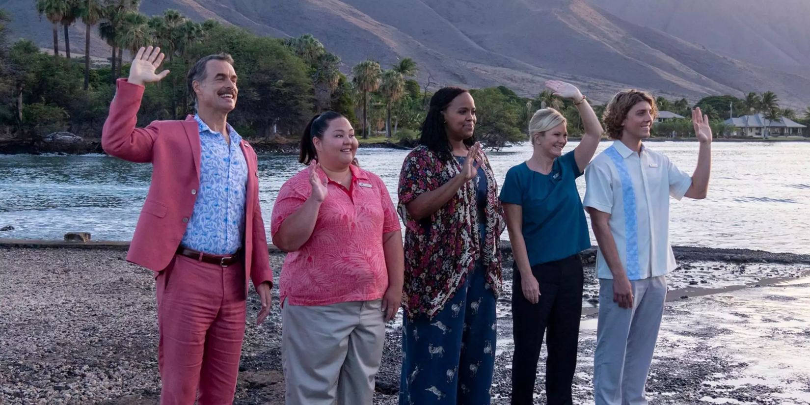 The White Lotus Staff on a beach waving