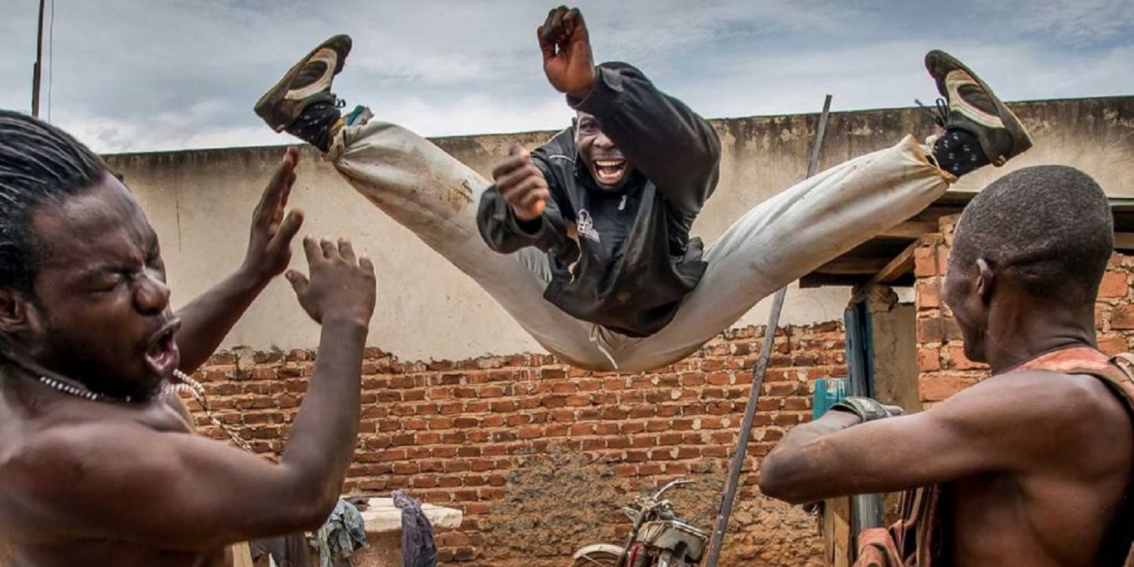 A person jumps into the air and does the splits in Who Killed Captain Alex.