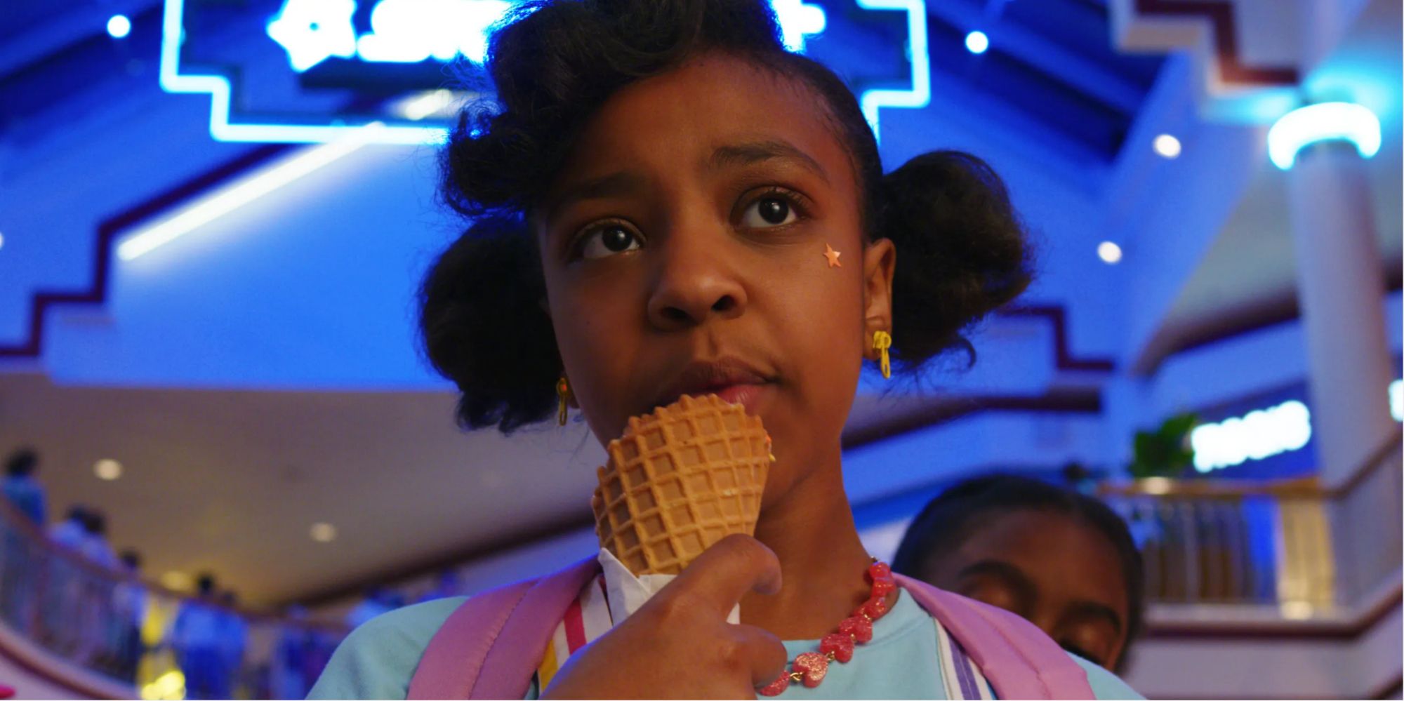 Erica Sinclair eating ice cream from a waffle cone 