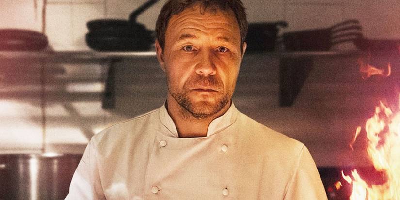 Andy Jones, wearing a chef's coat and looking into the camera, in Boiling Point.