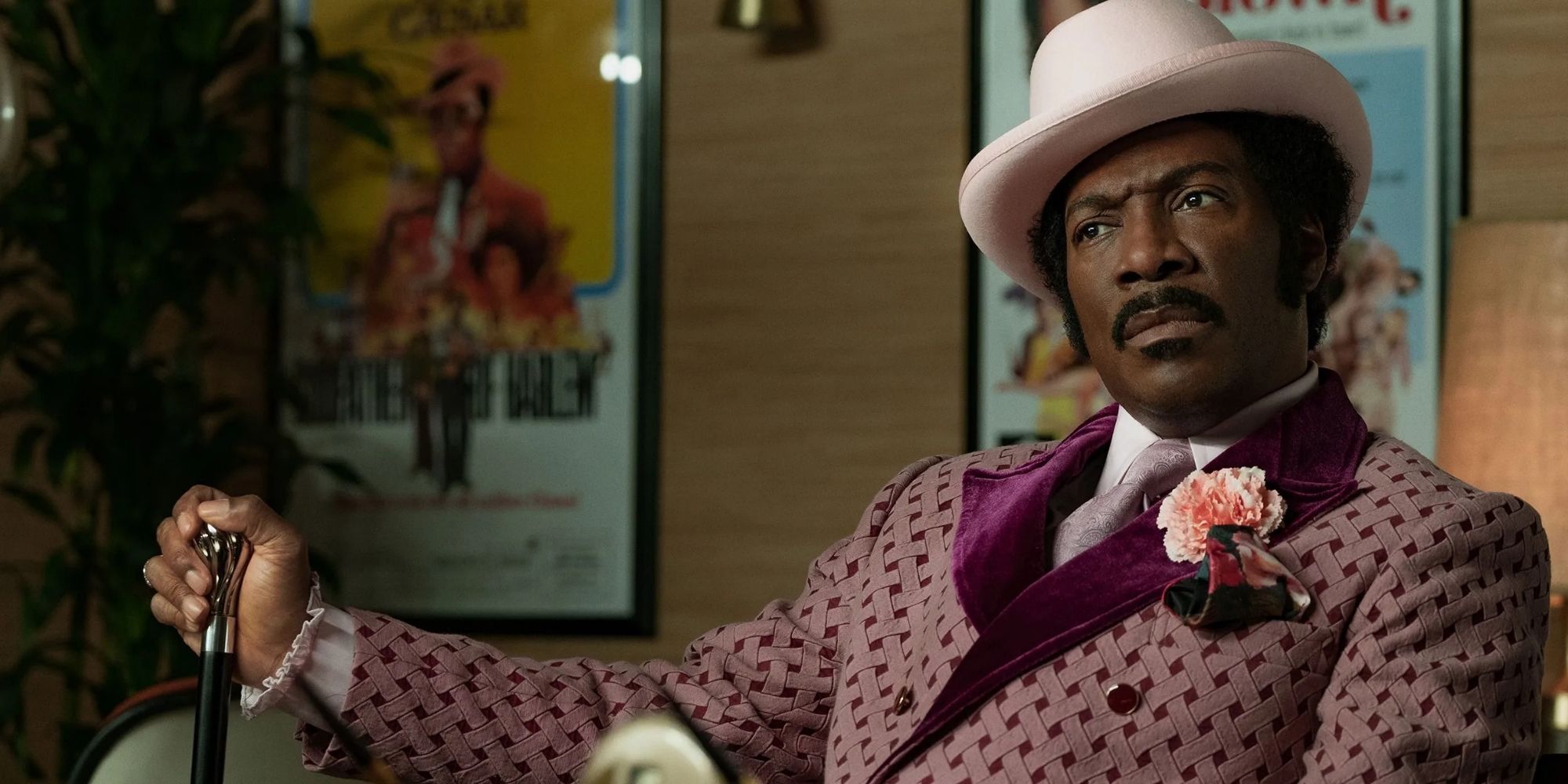 Rudy Ray Moore (Eddie Murphy) sits looking confused in Dolemite Is My Name