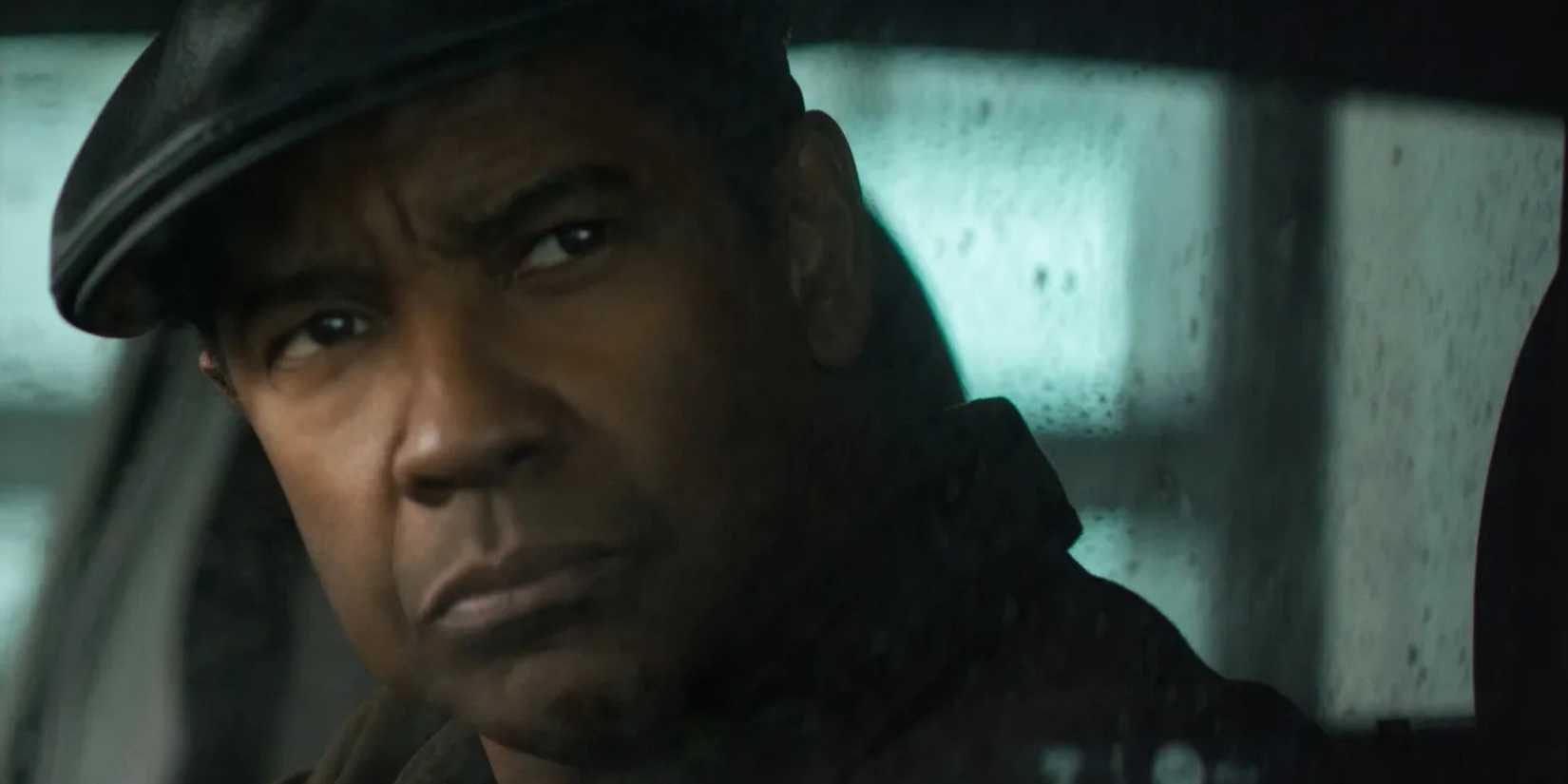 Robert McCall (Denzel Washington) surveys the scene from a car in 'The Equalizer' (2014).