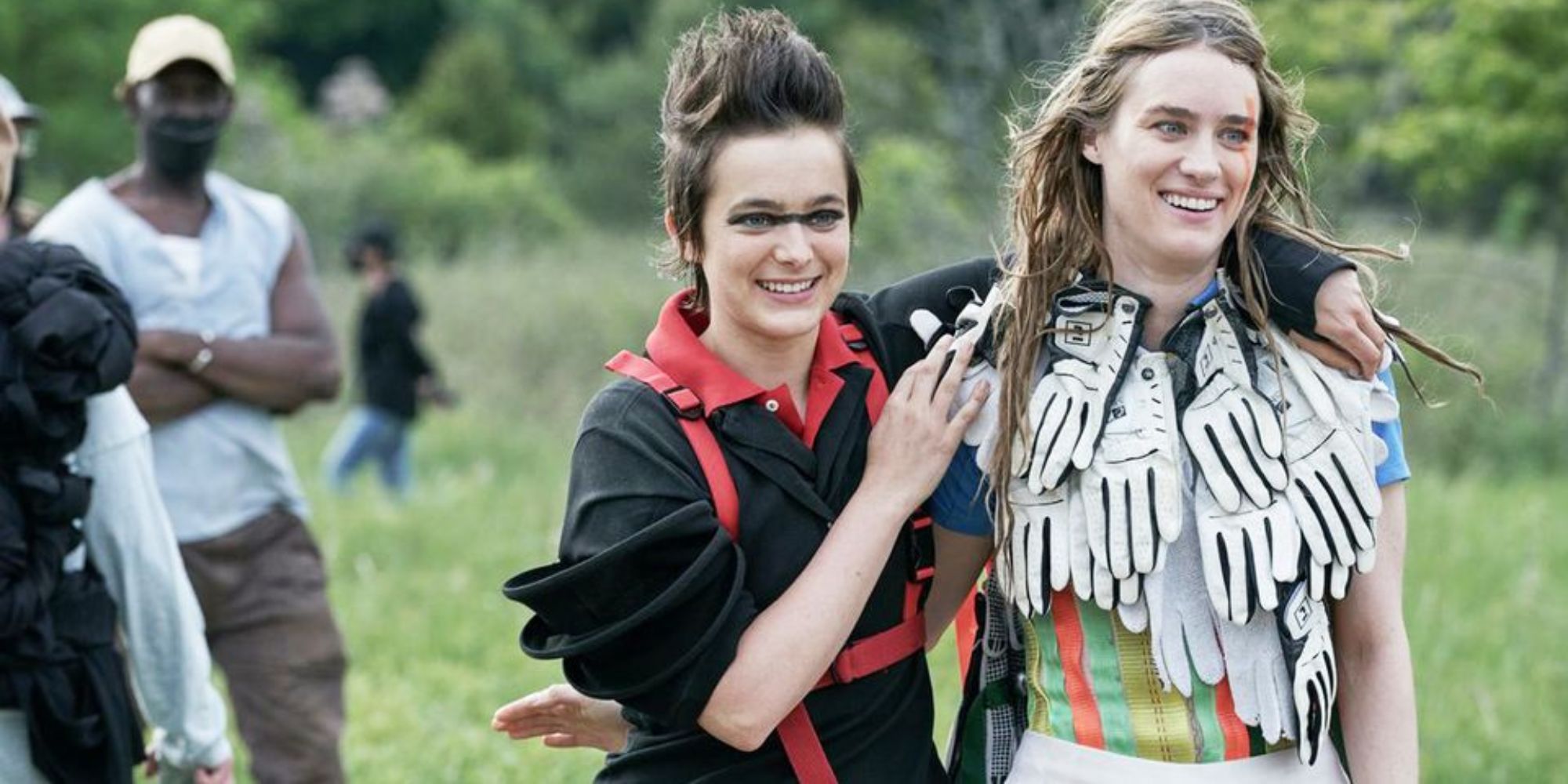 Two girls dressed in strange sense laughing and walking in the meadow