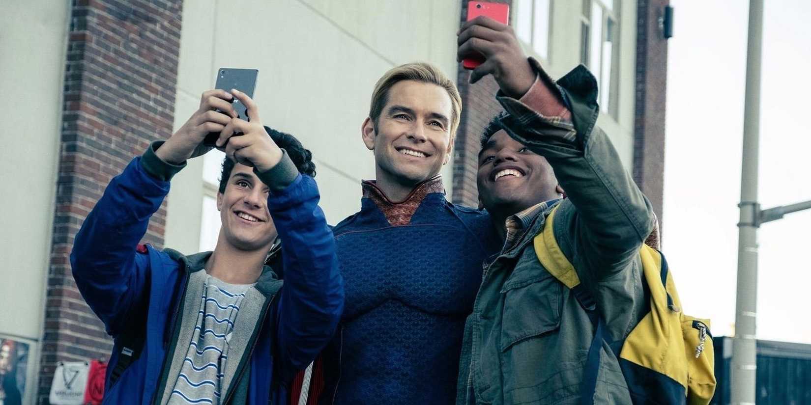 Antony Starr as Homelander taking pictures with fans in The Boys