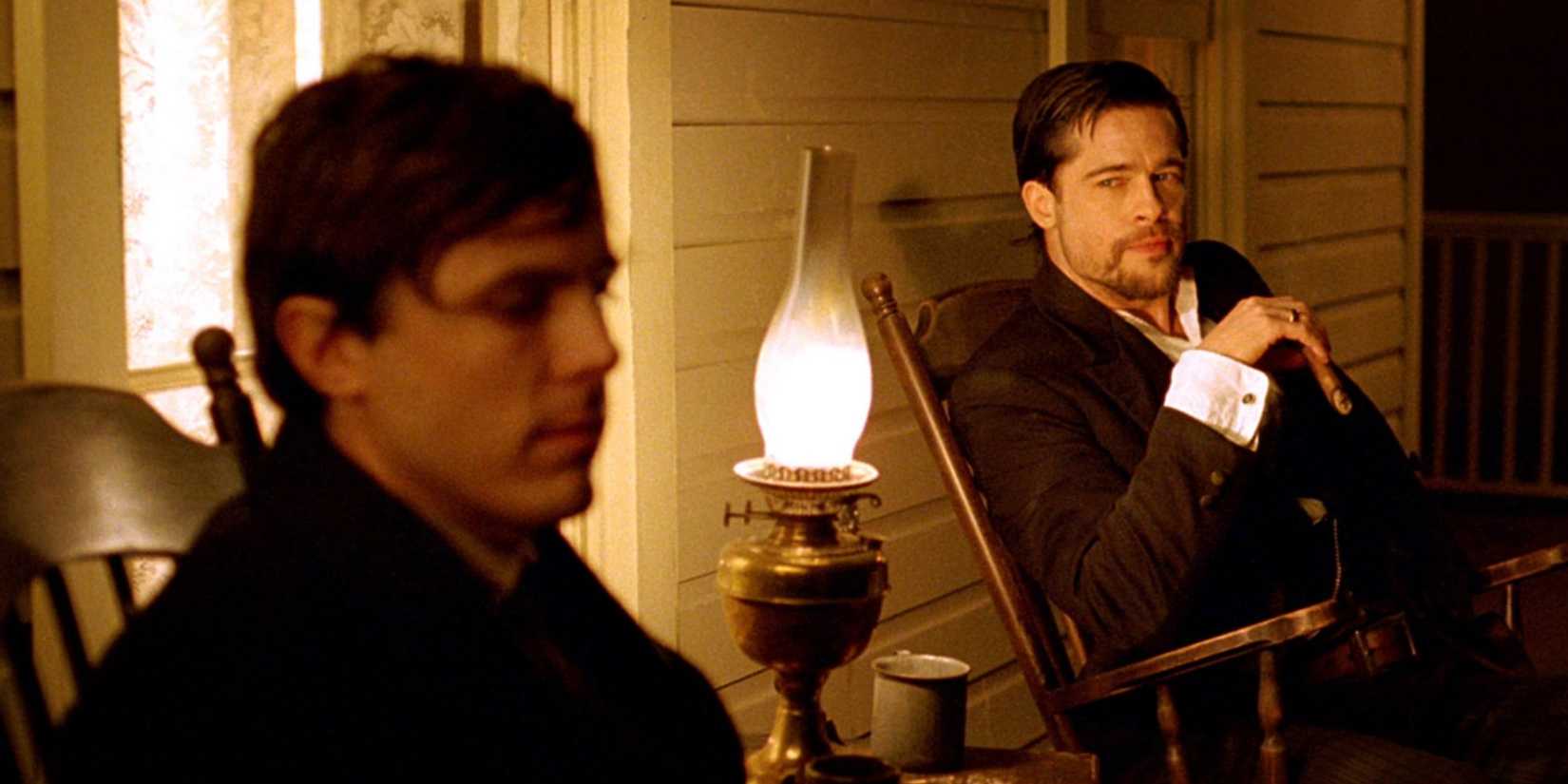 Jesse James sitting with Robert Ford in 'The Assassination of Jesse James by the Coward Robert Ford' (2007)