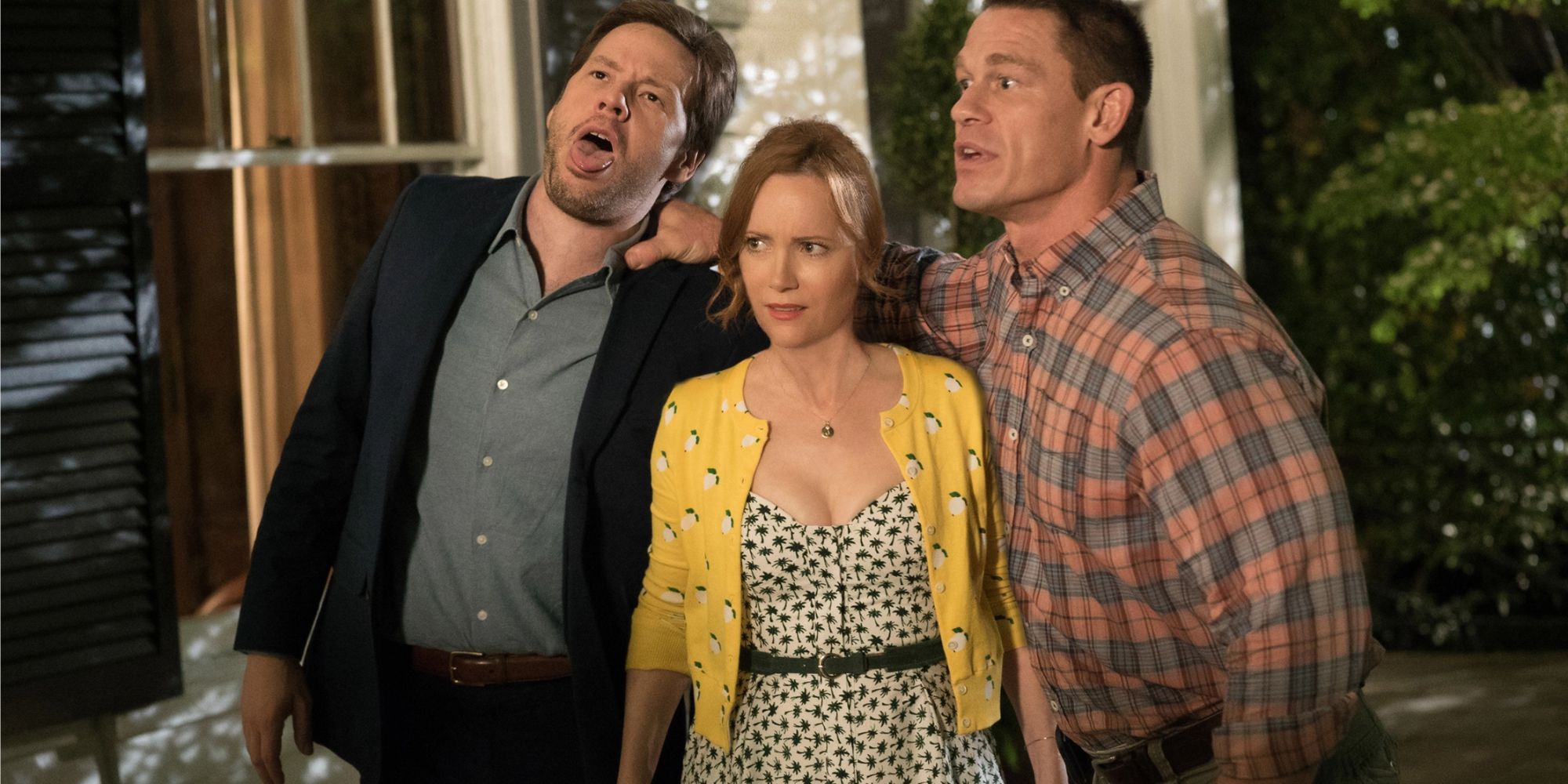 Ike Barinholtz, Leslie Mann and John Cena holding each other and looking confused