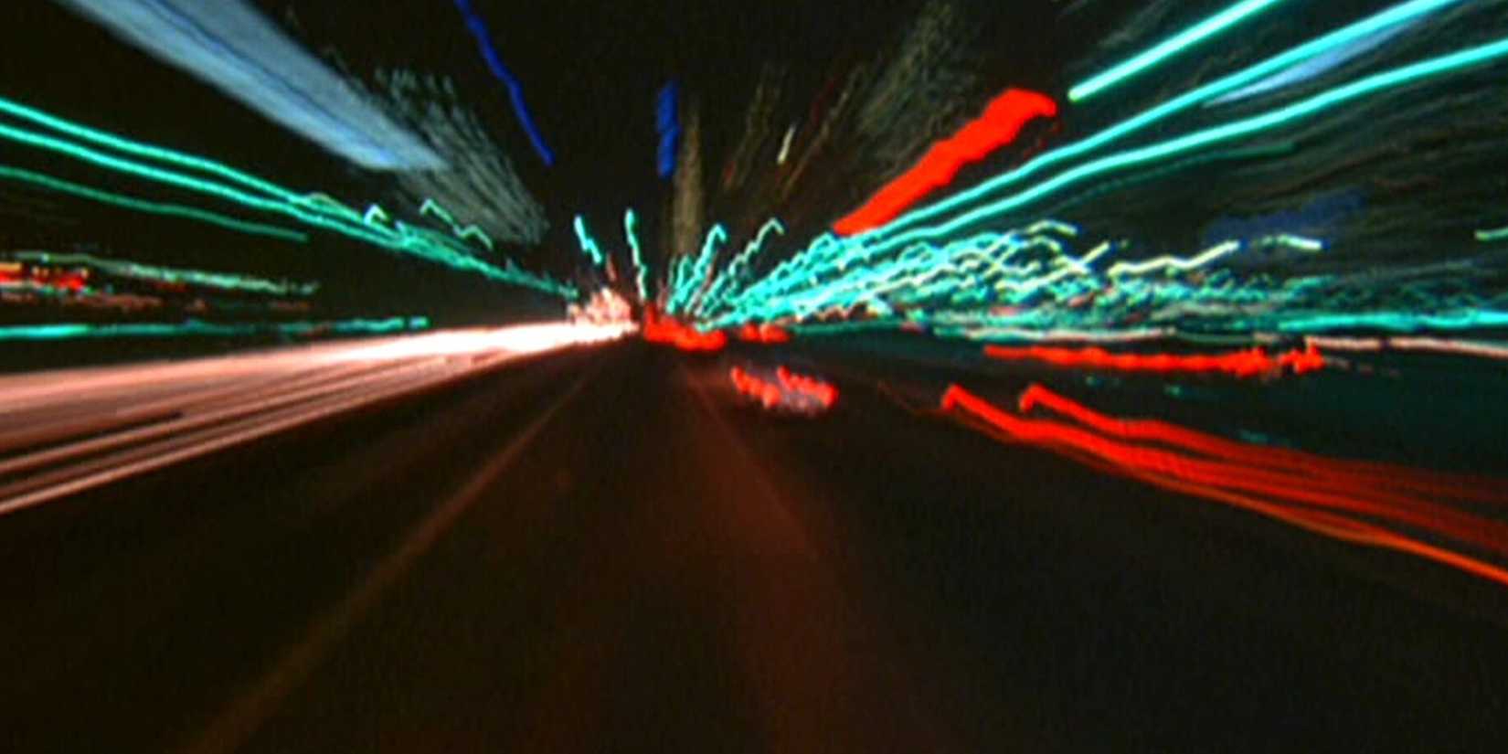 A blurry image of a cars going through a street in Koyaanisqatsi
