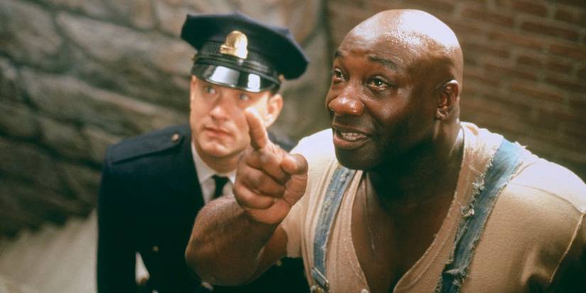 Michael Clarke Duncan as John smiles and points upward while Tom Hanks as Paul watches in The Green Mile.