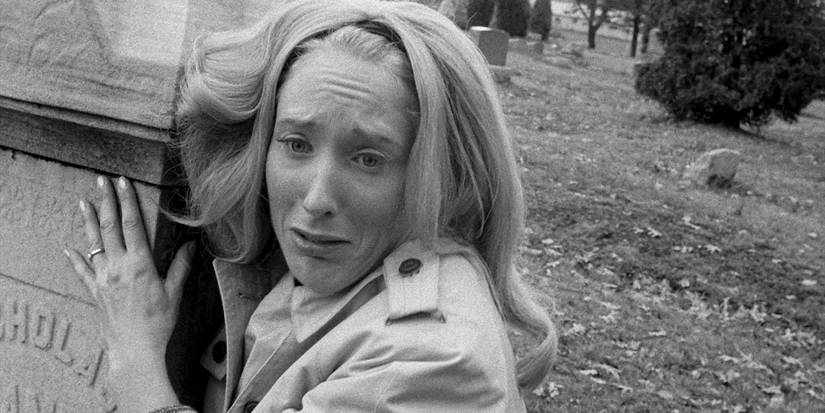 A terrified Barbara (Judith O'Dea) clutches a tombstone in 'Night of the Living Dead'