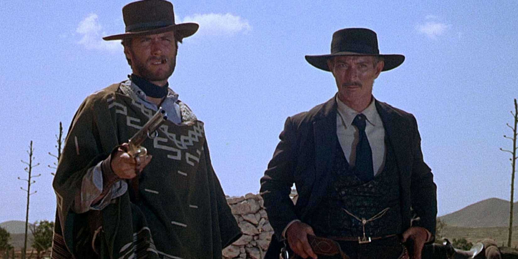 Clint Eastwood and Lee Van Cleef stand side by side outside in a Western setting in For a Few Dollars More.