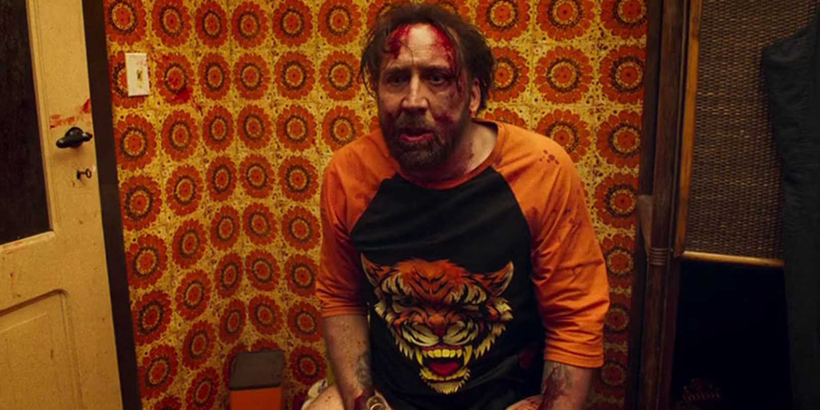 A bloody Nicolas Cage sitting on the toilet in Mandy.