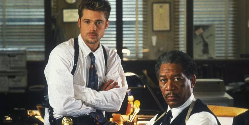 Detectives Mills and Sommerset next to each other in the office looking to camera in Se7en.
