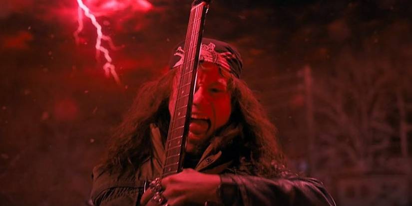 Eddie Munson, played by Joseph Quinn, playing guitar in the Upside Down in Stranger Things Season 4.