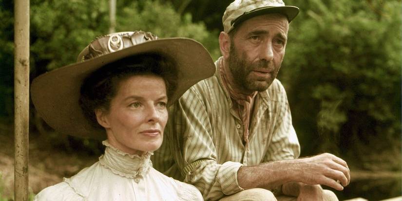 Humphrey Bogart sitting next to Katharine Hepburn in The African Queen