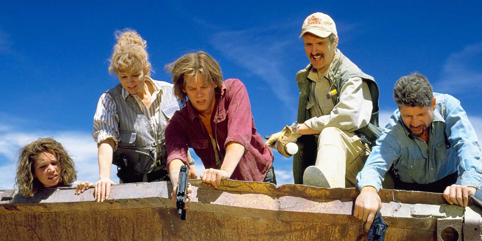 The cast of 'Tremors' looks down from a roof