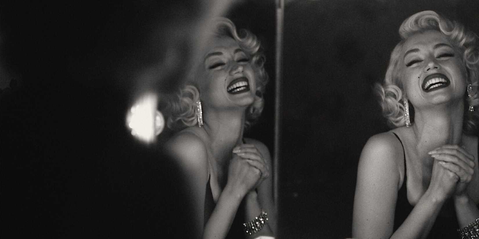 Marilyn Monroe smiling in front of a mirror in 'Blonde.'