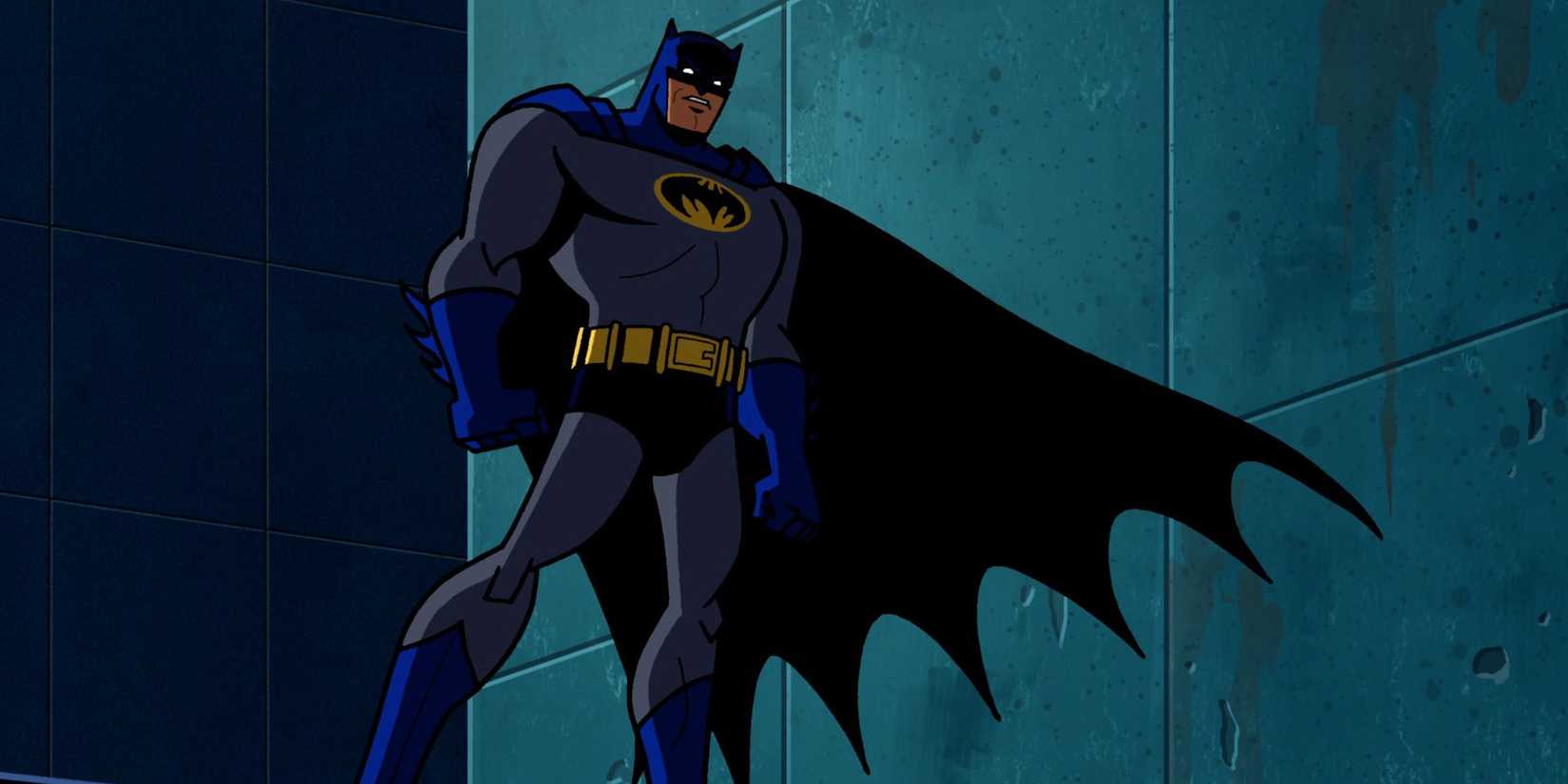 Batman stands on a building at night, cape waving, in Batman: the Brave and the Bold.