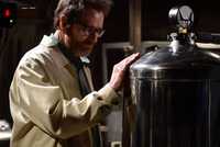 Walter White exploring his old lab, touching a metal tank in Breaking Bad.