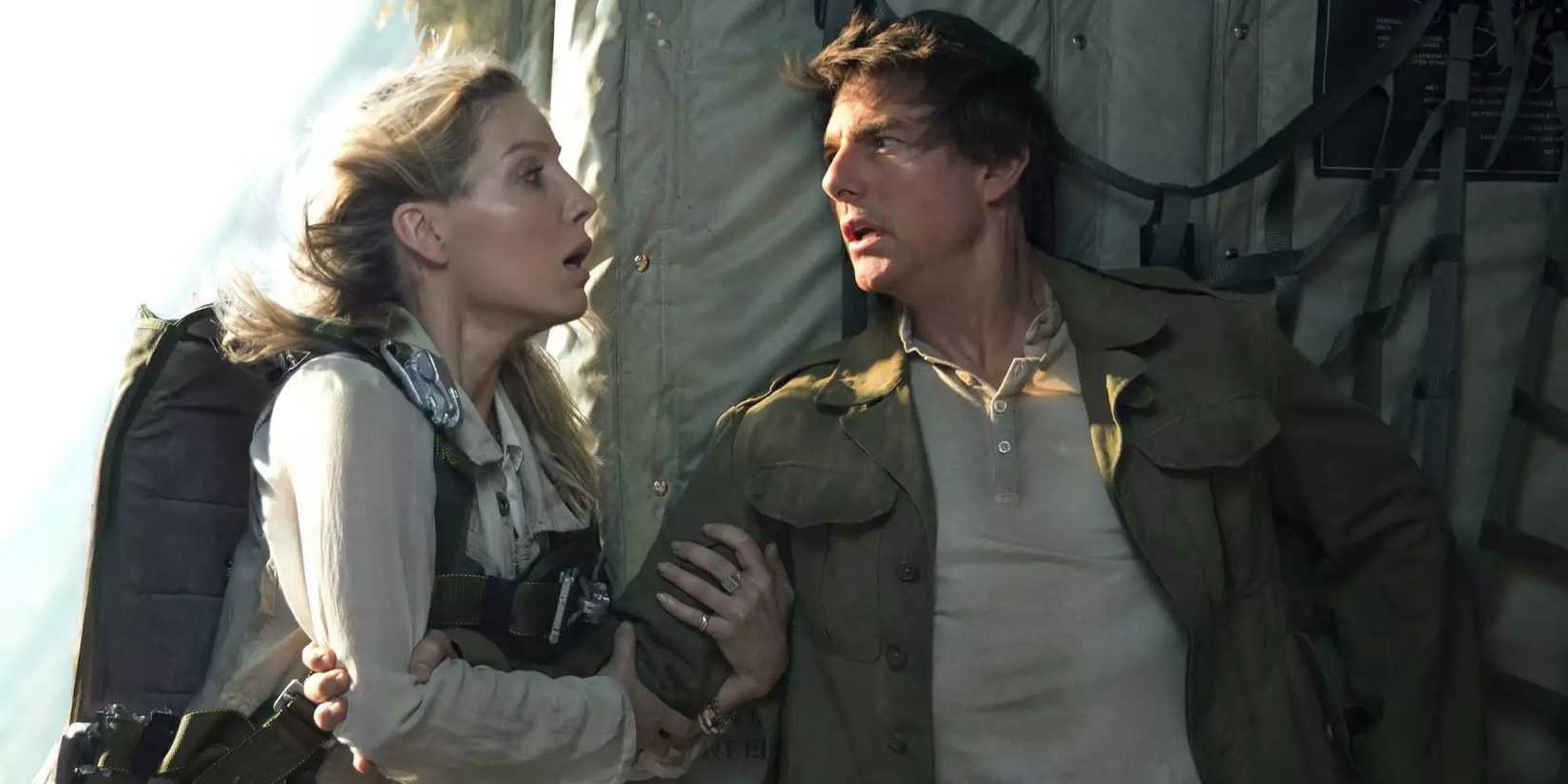 Annabelle Wallis holding on to Tom Cruise's arm in fear in 2017's The Mummy