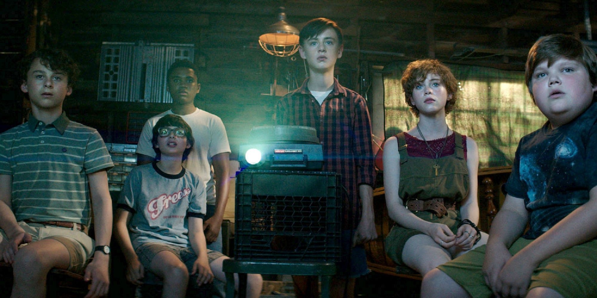The Losers Club, including actors Jaeden Martel, Sophia Lillis, Jeremy Ray Taylor, Finn Wolfhard, Jack Dylan Grazer, Wyatt Oleff watching the film in the basement in 'It.'