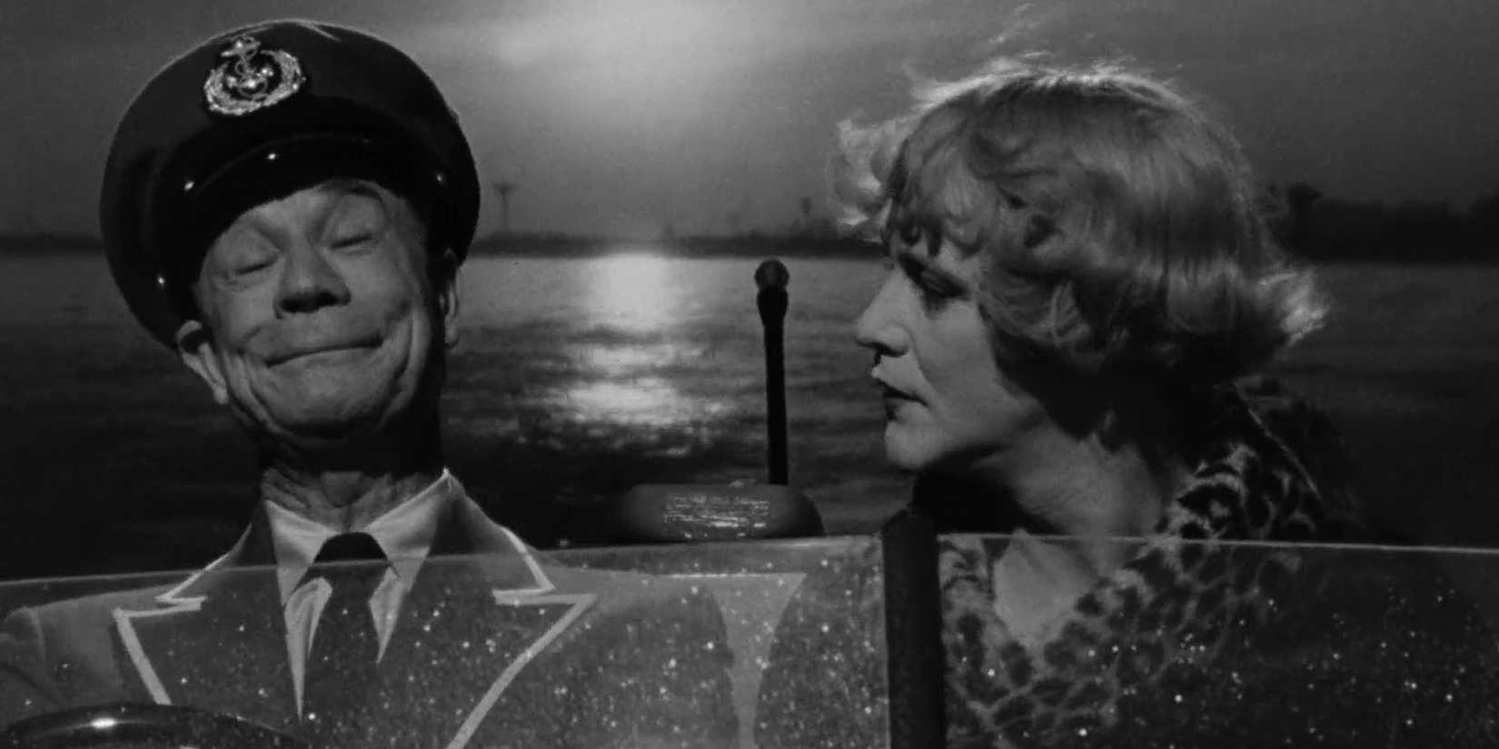 Jack Lemmon and Joe E Brown on a boat, driving away from the Sun