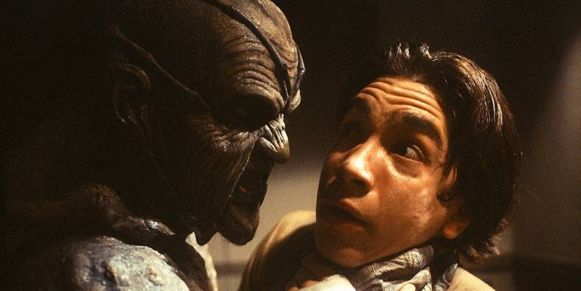 The Creeper holds a teen by the throat