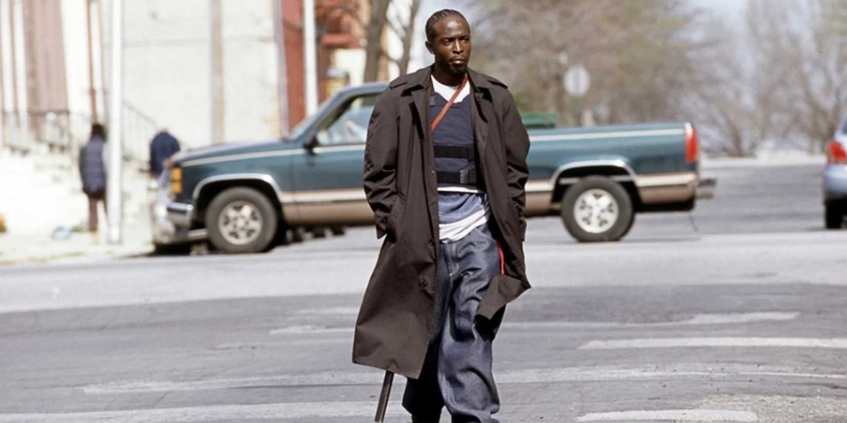 Omar Little crosses the street with his gun in The Wire.