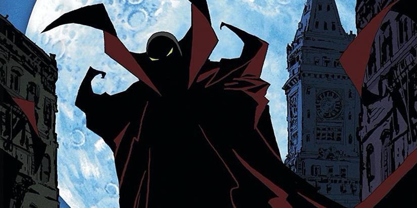 Spawn stands in a city at night with a large moon behind in the Spawn animated series.