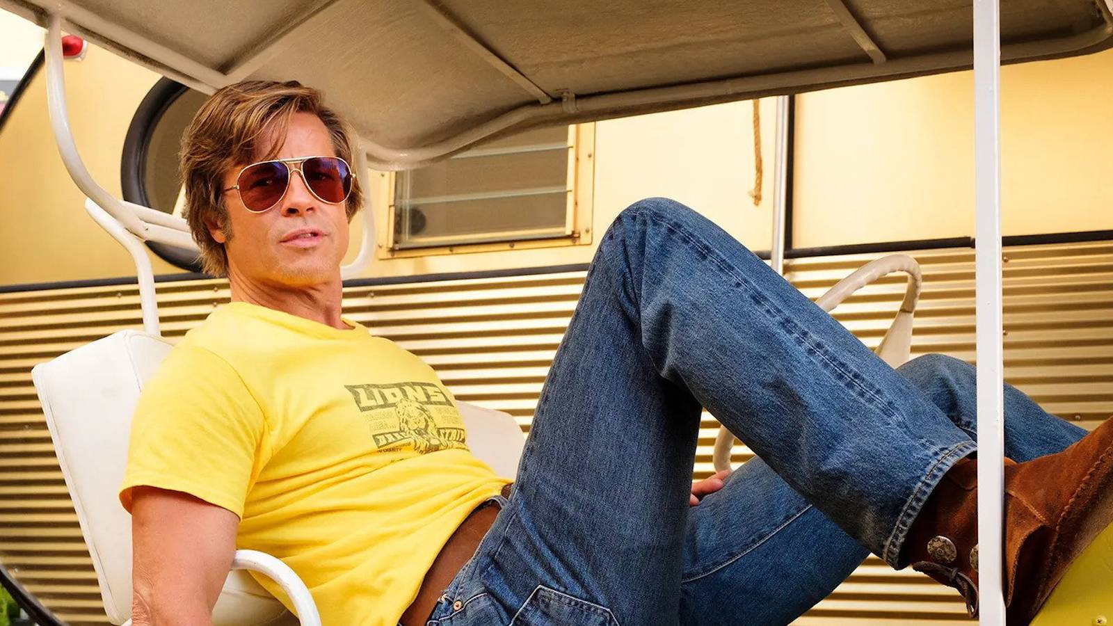 Cliff booth laying in a golf cart in Once Upon a Time in Hollywood
