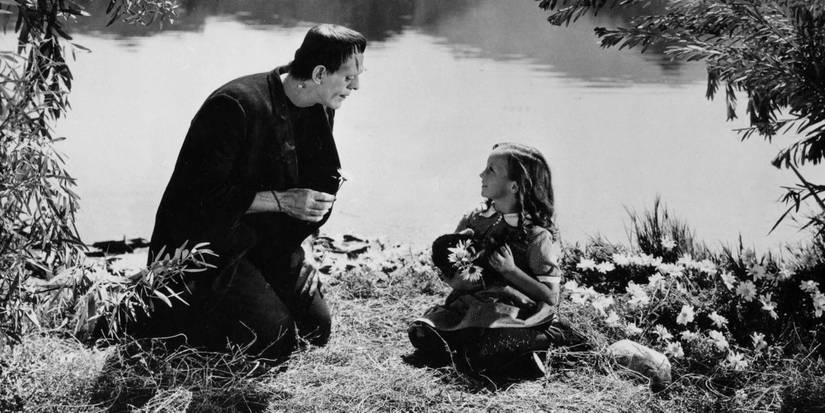 A little girl sits by a creature by the river