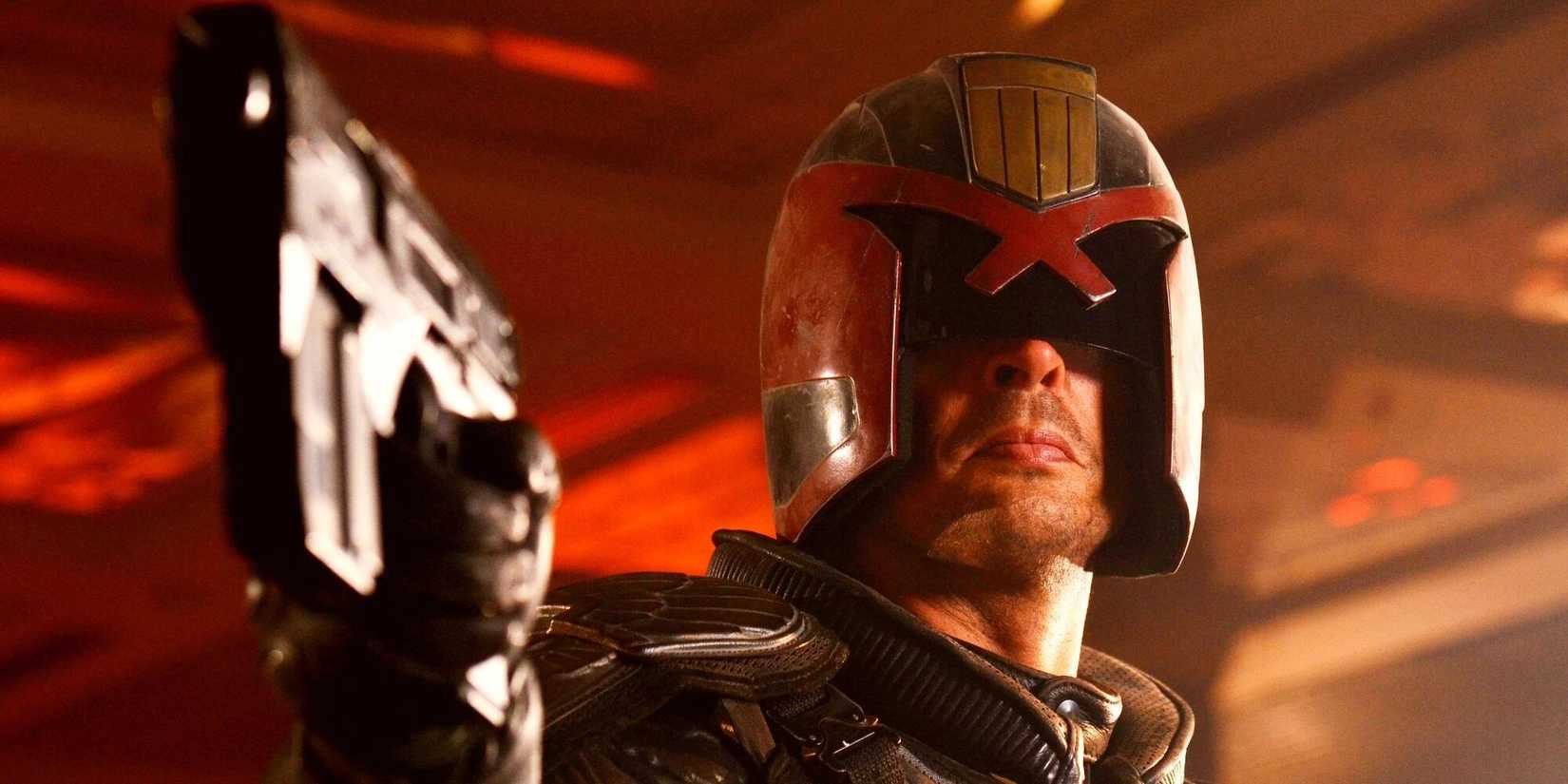Karl Urban as Judge Dredd aiming a gun at something off-camera