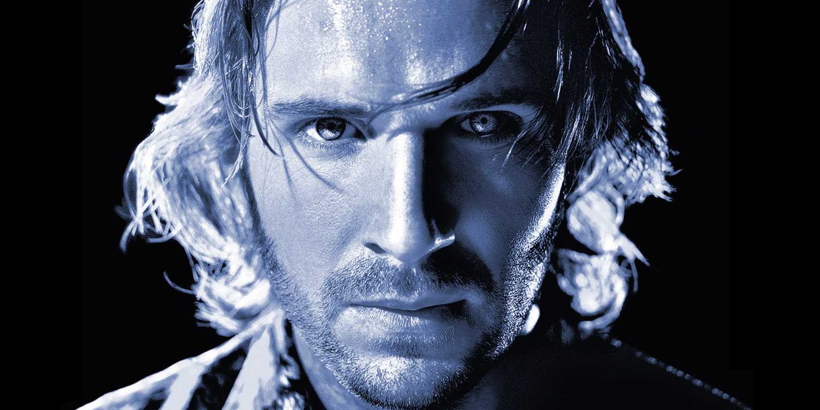 Ralph Fiennes looking ahead in a dramatically lit close-up for Strange Days.
