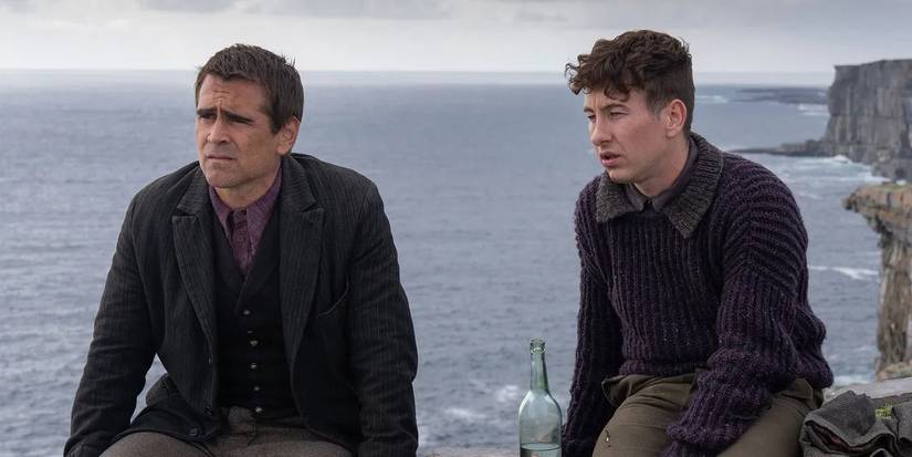 Colin Farrell and Barry Keoghan as Pádraic and Dominic, sitting on a cliff and looking dismayed in The Banshees of Inisherin
