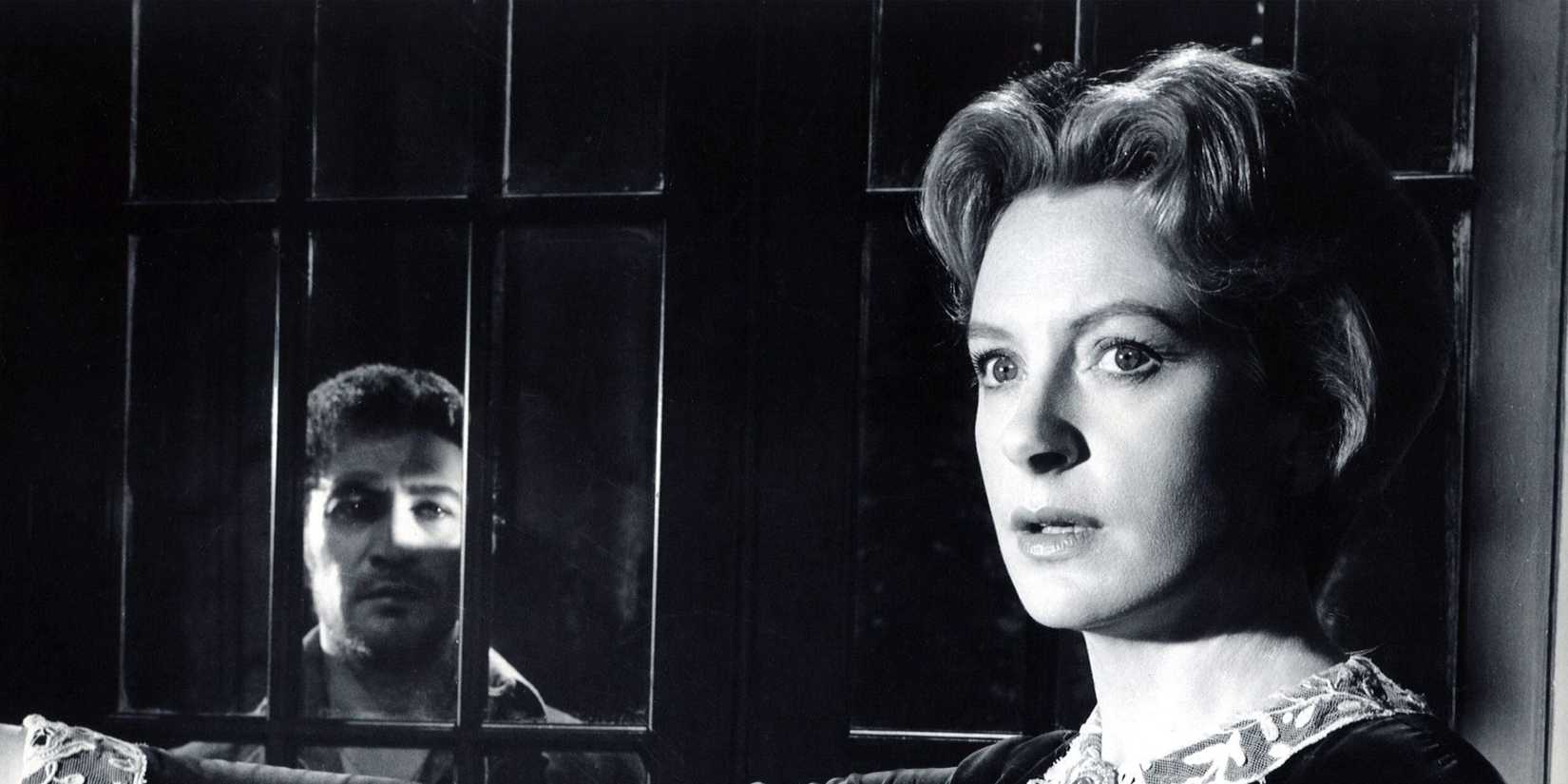 A woman and a man who is separated by a jail bar